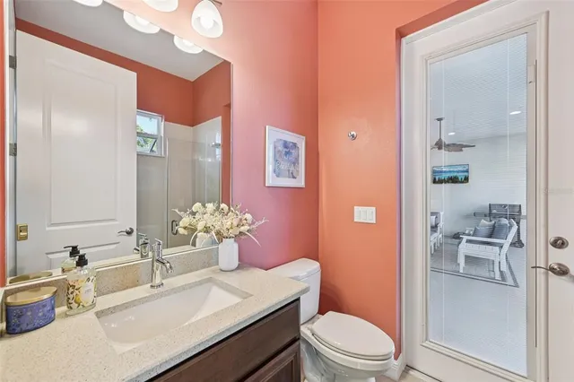 a bathroom with a sink vanity mirror and toilet