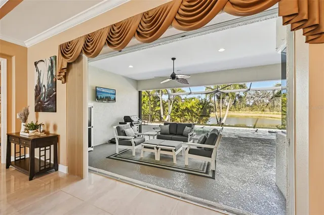 a dining room with furniture and a large window