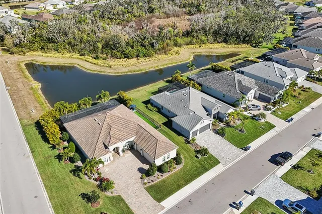 an aerial view of residential houses with outdoor space and swimming pool