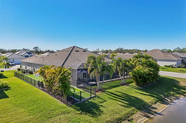 an aerial view of a house with a yard basket ball court and outdoor seating