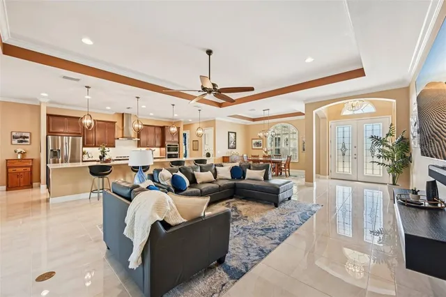 a living room with lots of furniture and a large window