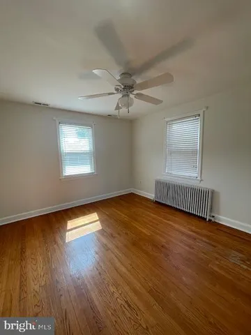 a view of an empty room and wooden floor