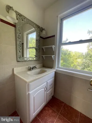 an empty room with wooden floor and chandelier fan