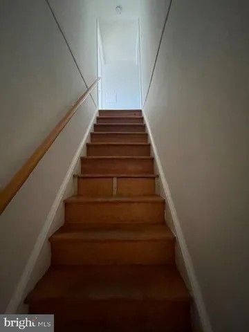 a view of room and hall with wooden floor