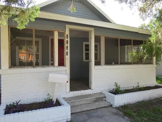 front view of a house with a potted plant
