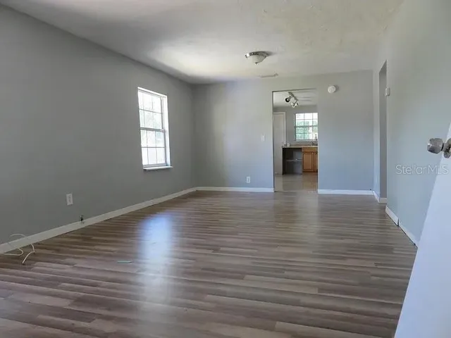 wooden floor in an empty room with a window