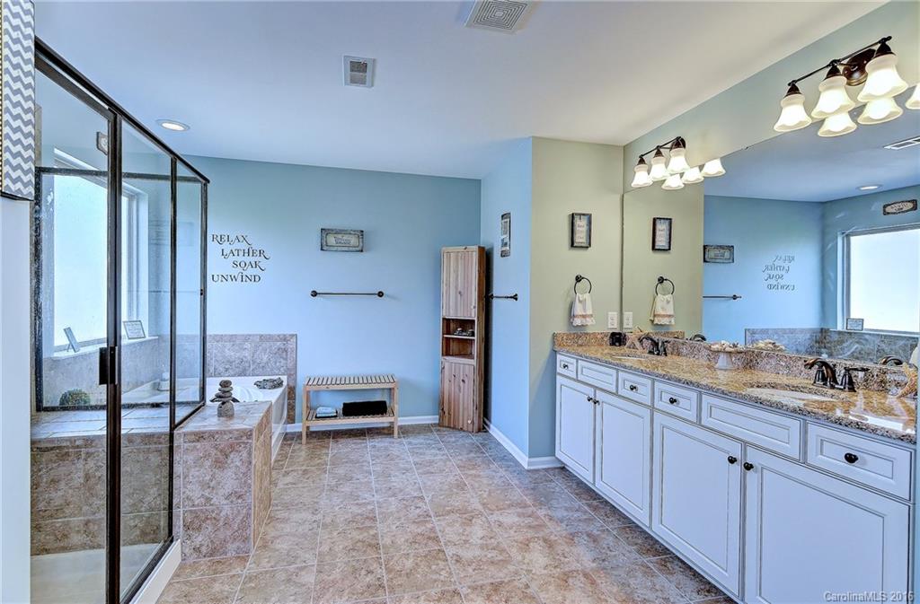 1428 Ridgehaven Road Waxhaw, NC 28173 - Photo 13 of 24 a spacious bathroom with a granite countertop sink a mirror and shower