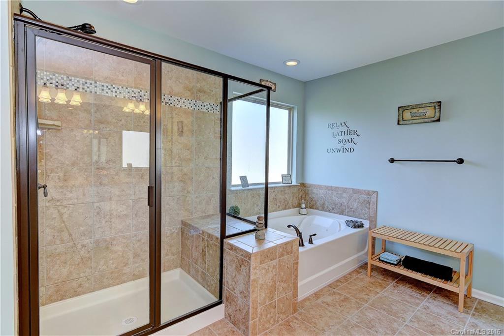 1428 Ridgehaven Road Waxhaw, NC 28173 - Photo 14 of 24 a bathroom with a bathtub and a shower