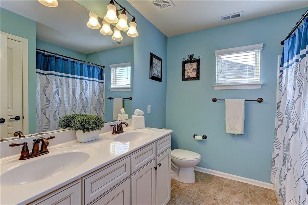 1428 Ridgehaven Road Waxhaw, NC 28173 - Photo 17 of 24 a bathroom with a toilet a sink and mirror