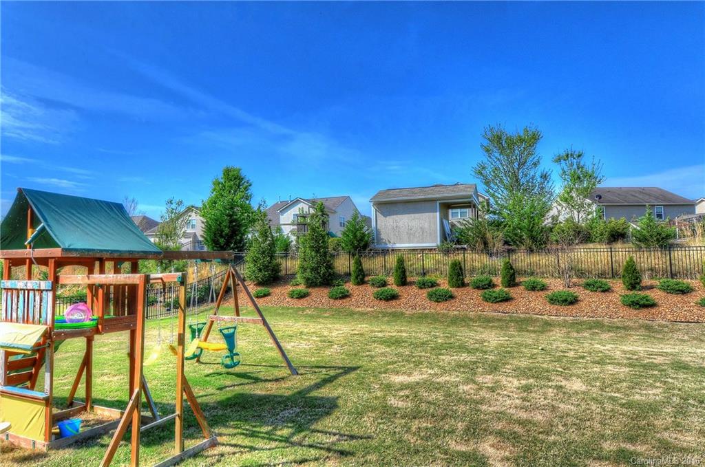 1428 Ridgehaven Road Waxhaw, NC 28173 - Photo 20 of 24 a view of swimming pool with lawn chairs under an umbrella