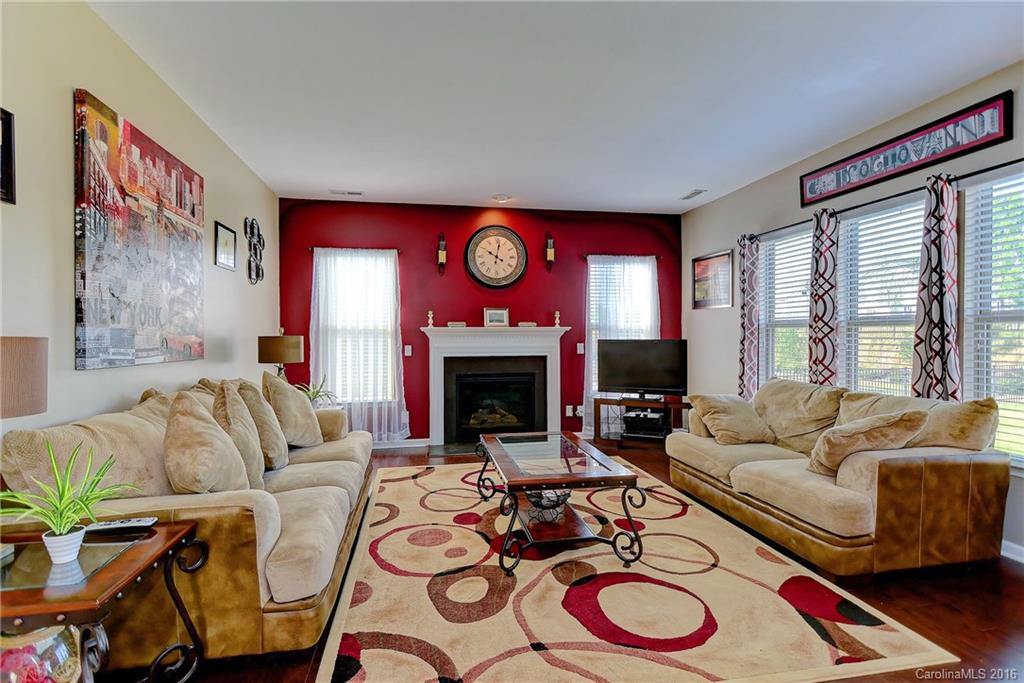 1428 Ridgehaven Road Waxhaw, NC 28173 - Photo 10 of 24 a living room with furniture a fireplace and a large window