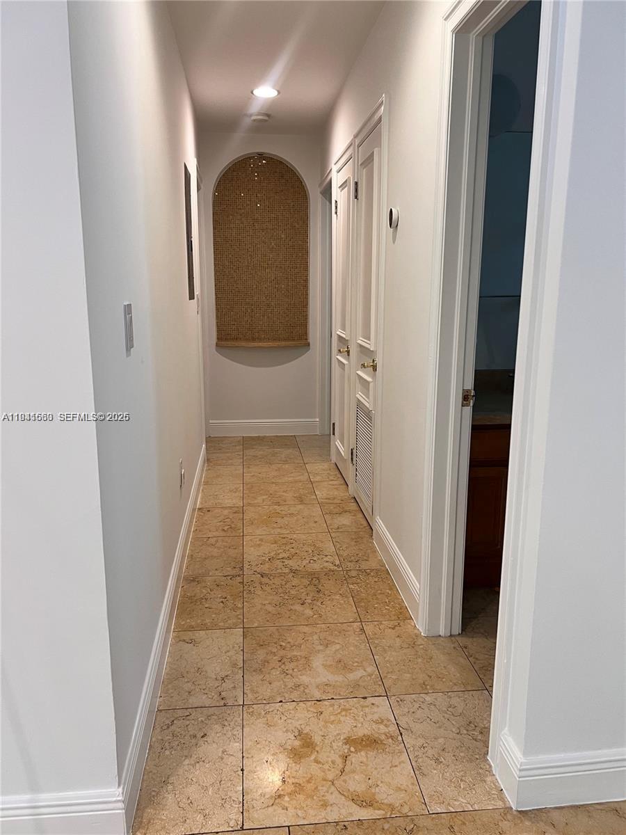 7350 Southwest 96th Street, Unit 7350 Pinecrest, FL 33156 - Photo 11 of 25 a view of a hallway with wooden floor and staircase