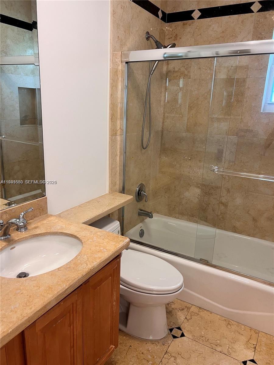 7350 Southwest 96th Street, Unit 7350 Pinecrest, FL 33156 - Photo 12 of 25 a bathroom with a sink a toilet and shower