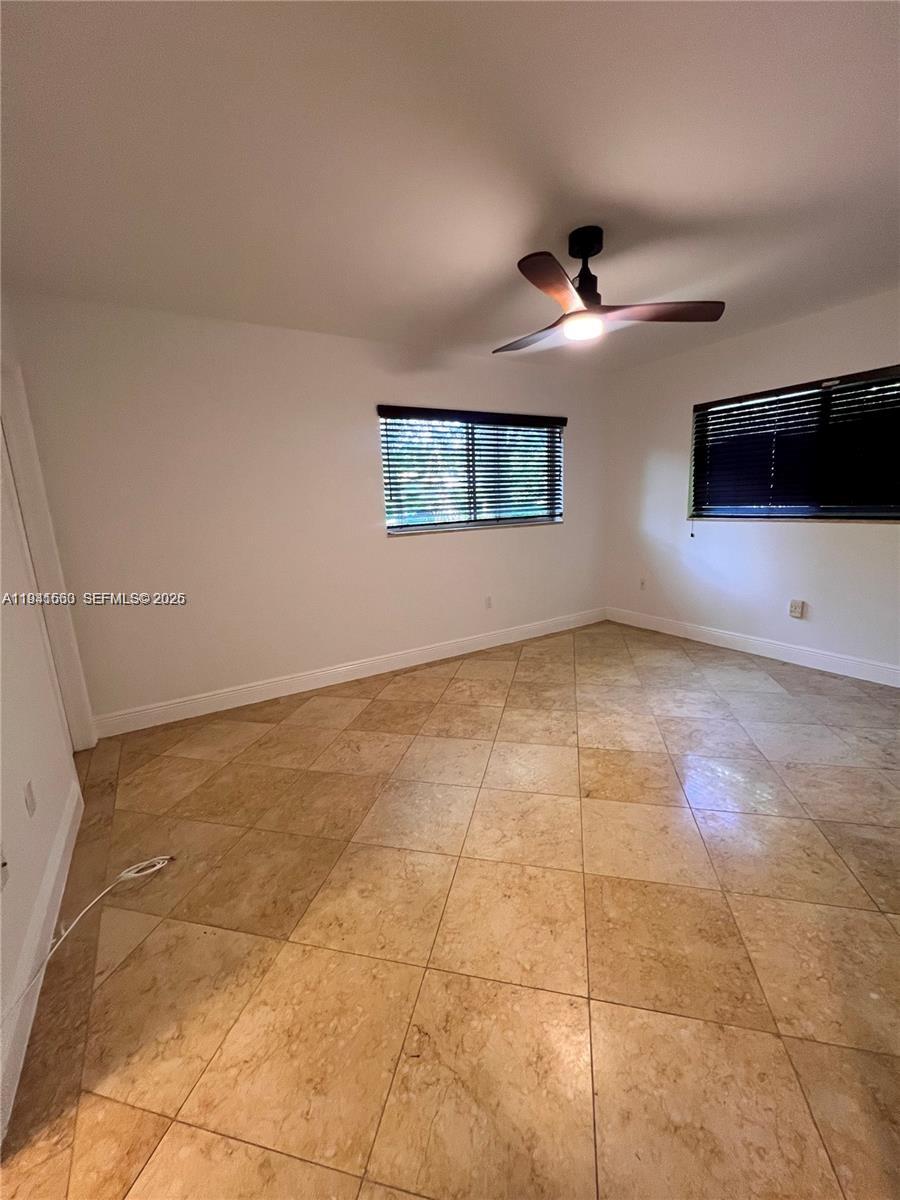 7350 Southwest 96th Street, Unit 7350 Pinecrest, FL 33156 - Photo 13 of 25 a view of an empty room with a window