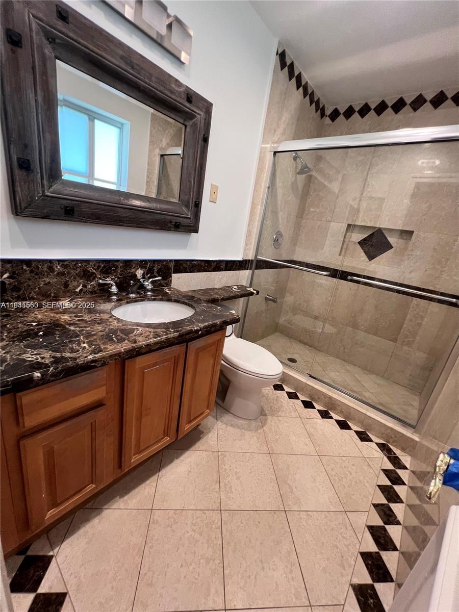 7350 Southwest 96th Street, Unit 7350 Pinecrest, FL 33156 - Photo 15 of 25 a kitchen with a sink a stove and cabinets