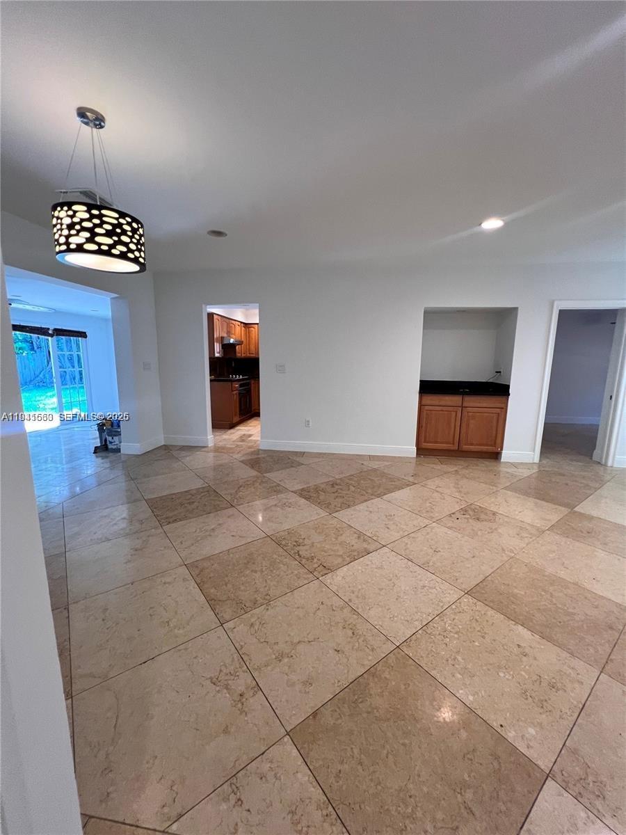 7350 Southwest 96th Street, Unit 7350 Pinecrest, FL 33156 - Photo 17 of 25 an empty room with windows and flowerpot