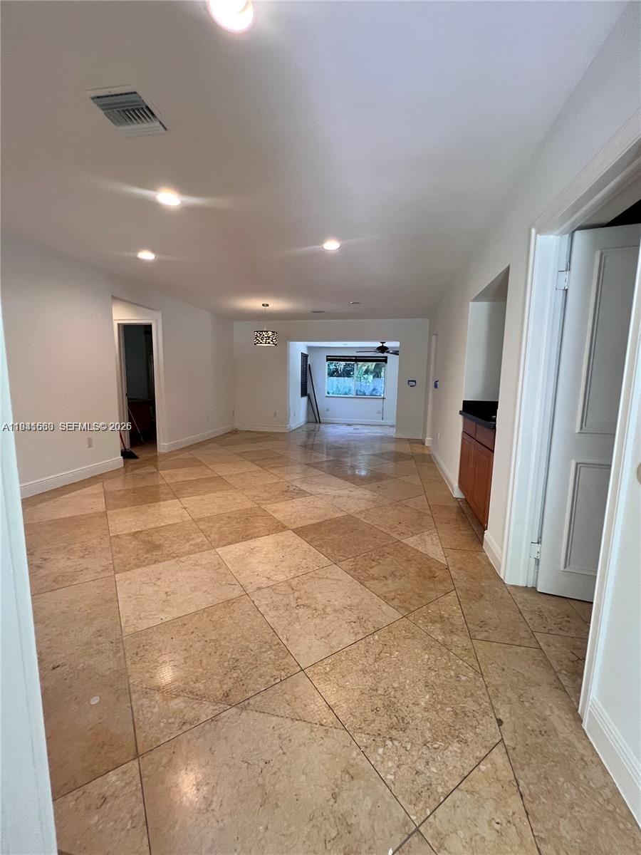 7350 Southwest 96th Street, Unit 7350 Pinecrest, FL 33156 - Photo 8 of 25 a view of an empty room with a fireplace