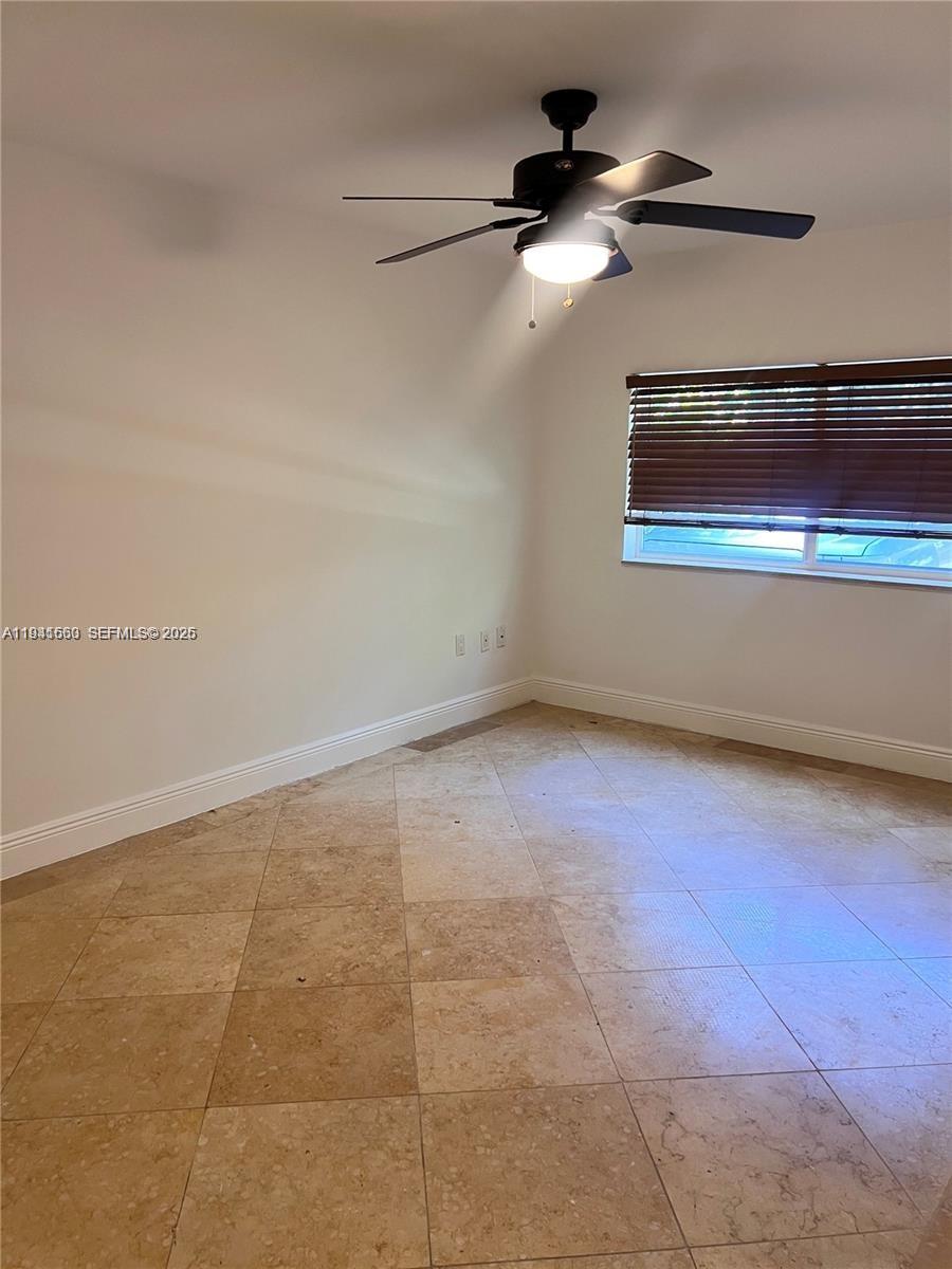 7350 Southwest 96th Street, Unit 7350 Pinecrest, FL 33156 - Photo 10 of 25 a view of an empty room with a window