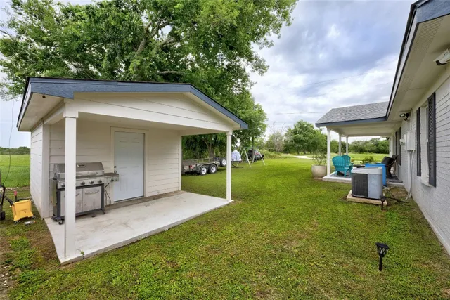 a view of an house with backyard space and garden