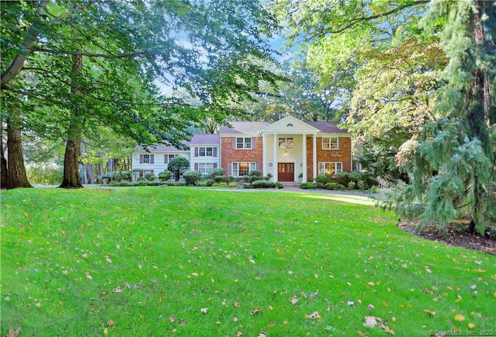 a front view of house with yard and green space