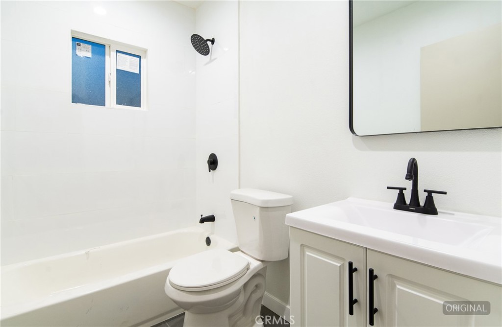 1100 East Tichenor Street Compton, CA 90221 - Photo 14 of 34 a bathroom with a sink a toilet and shower