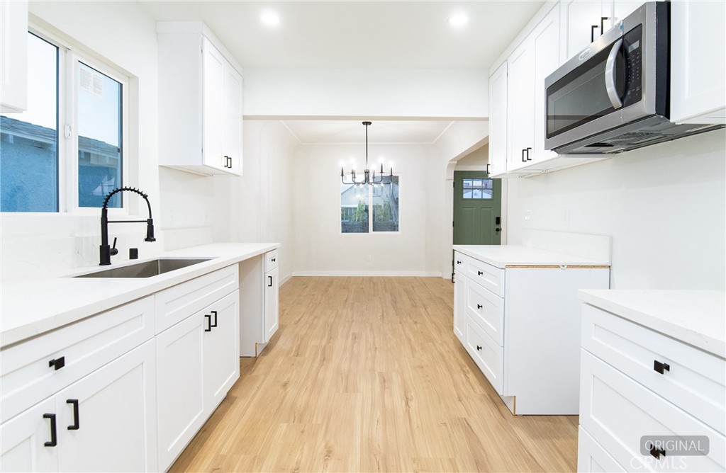 1100 East Tichenor Street Compton, CA 90221 - Photo 20 of 34 a kitchen with stainless steel appliances a stove microwave and cabinets