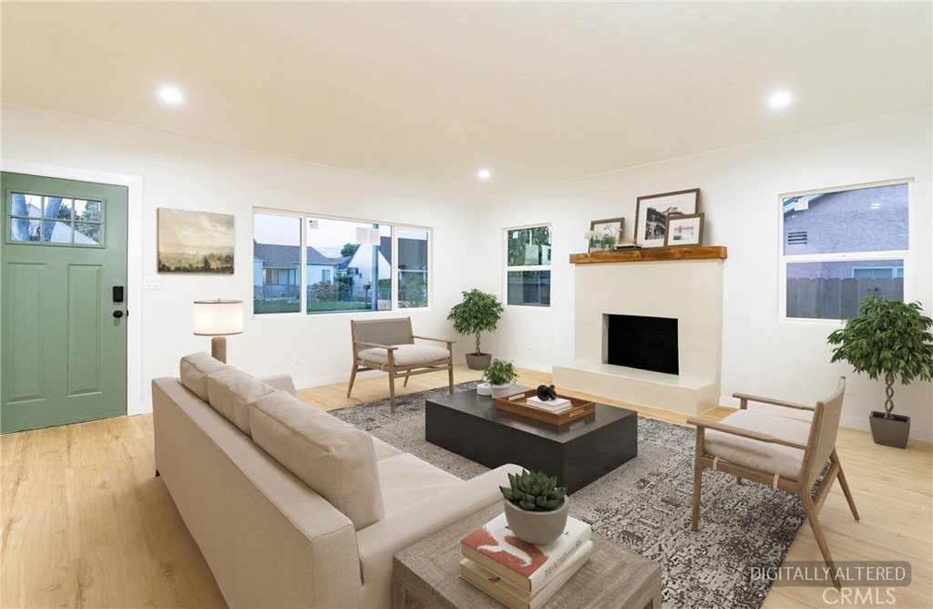 1100 East Tichenor Street Compton, CA 90221 - Photo 21 of 34 a living room with furniture a rug and a fireplace