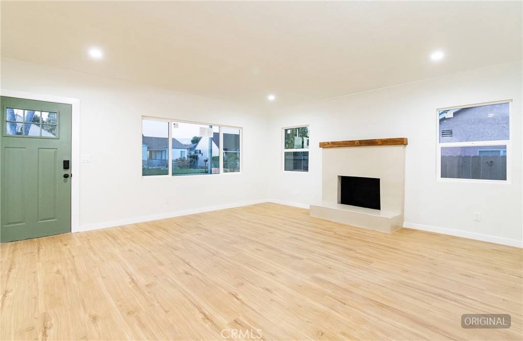 1100 East Tichenor Street Compton, CA 90221 - Photo 22 of 34 a view of empty room with wooden floor and fireplace