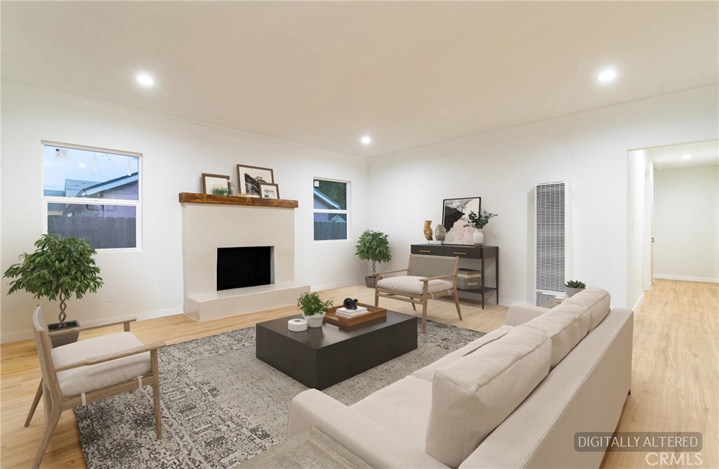 1100 East Tichenor Street Compton, CA 90221 - Photo 23 of 34 a living room with furniture a fireplace and a potted plant