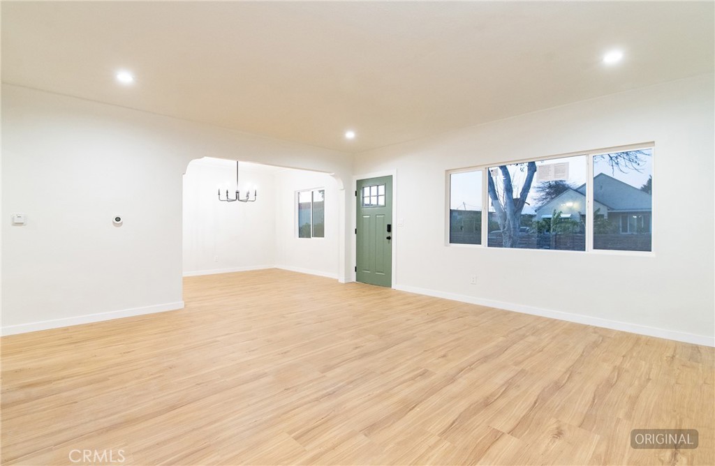 1100 East Tichenor Street Compton, CA 90221 - Photo 6 of 34 a view of an empty room with wooden floor and a window