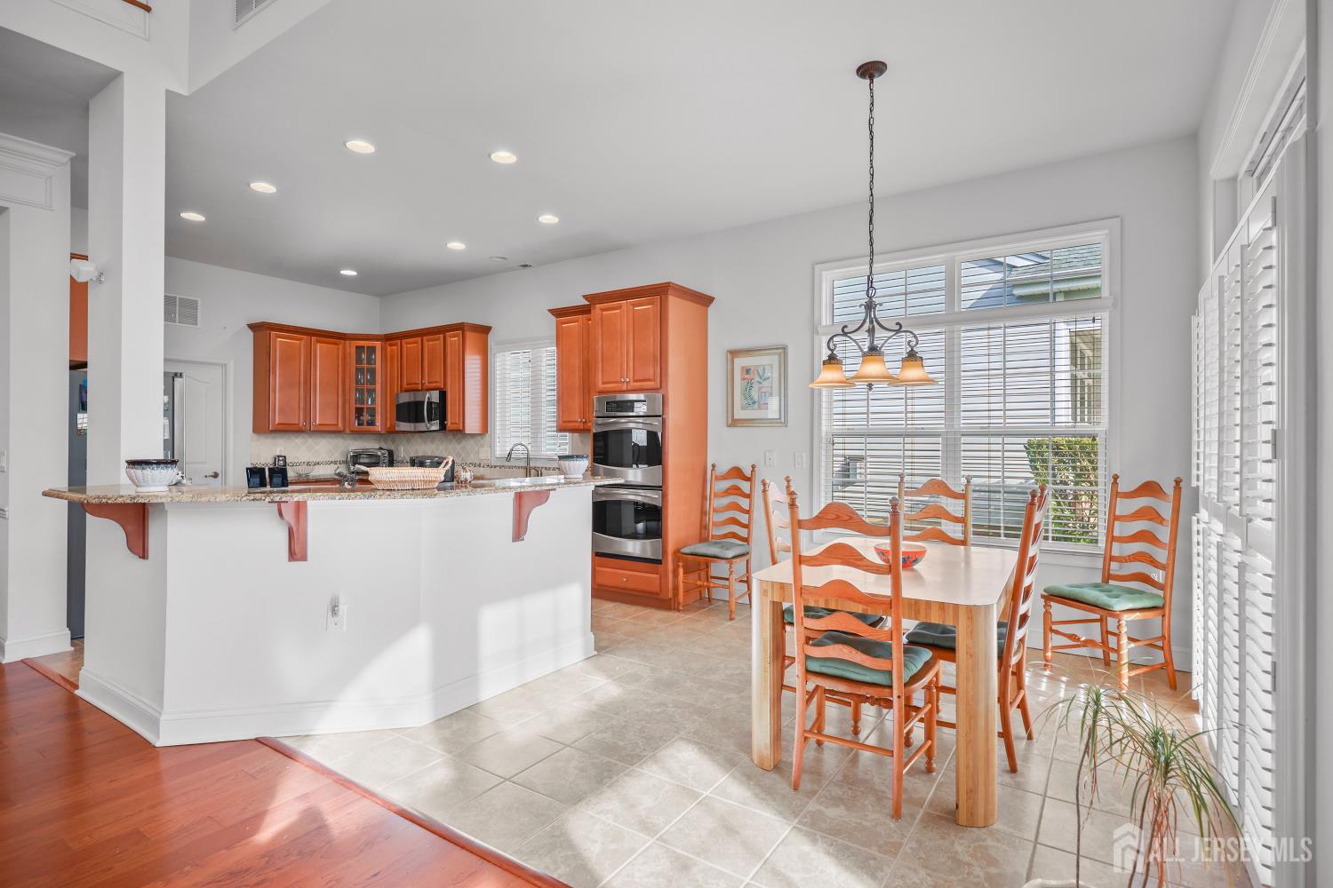 46 Mandrake Road Monroe Township, NJ 08831 - Photo 18 of 58 a kitchen with stainless steel appliances kitchen island granite countertop a refrigerator and microwave