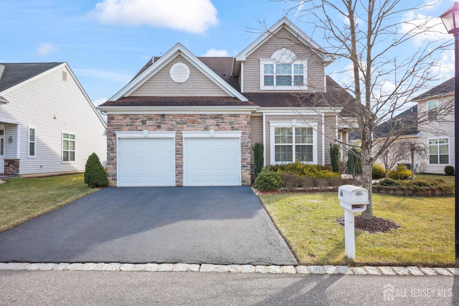 46 Mandrake Road Monroe Township, NJ 08831 - Photo 4 of 58 a front view of a house with a yard and garage
