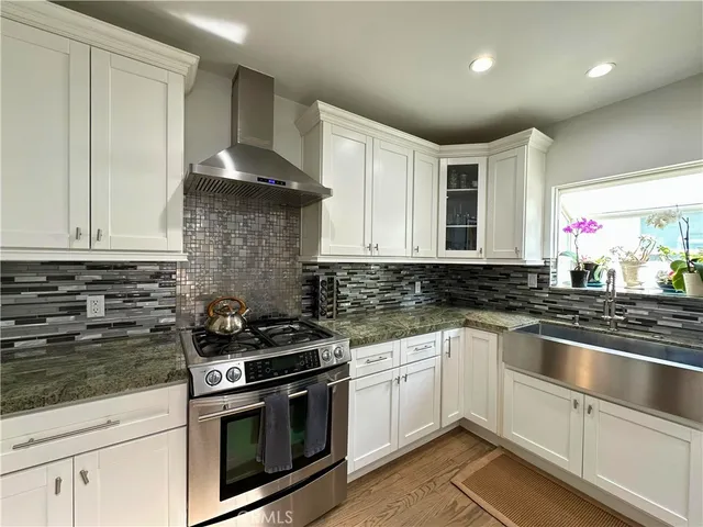 a kitchen with a table chairs stove and cabinets