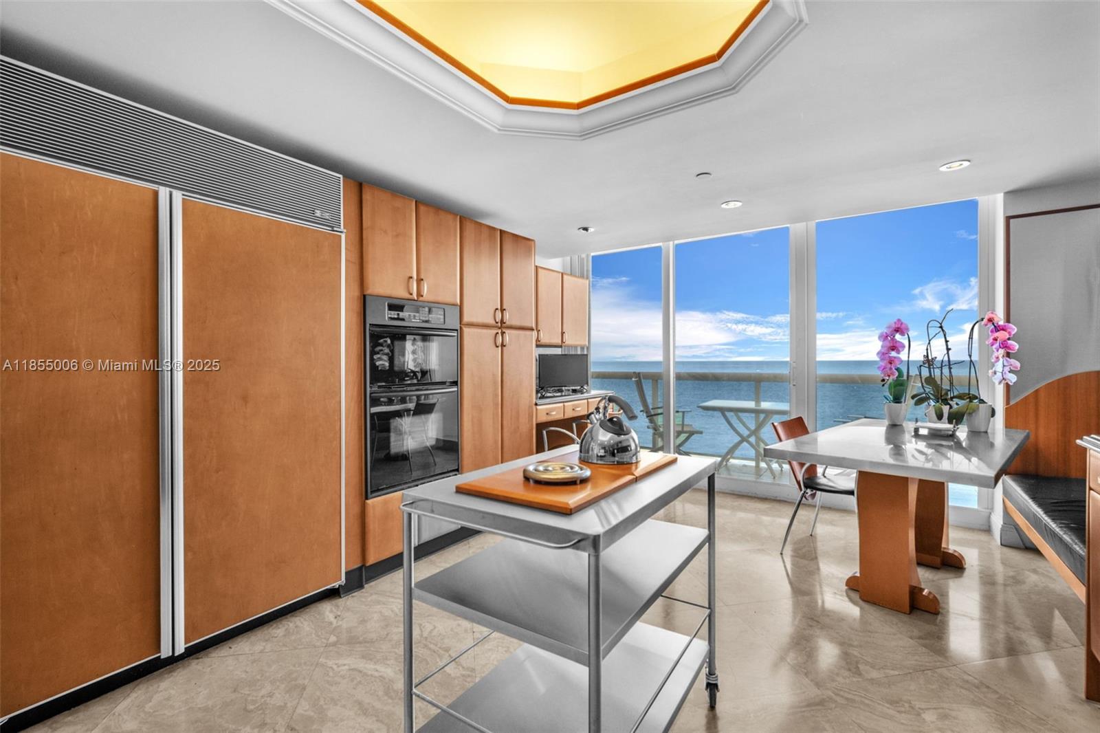 9595 Collins Avenue, Unit N9A Surfside, FL 33154 - Photo 17 of 66 a room with furniture a window and a kitchen