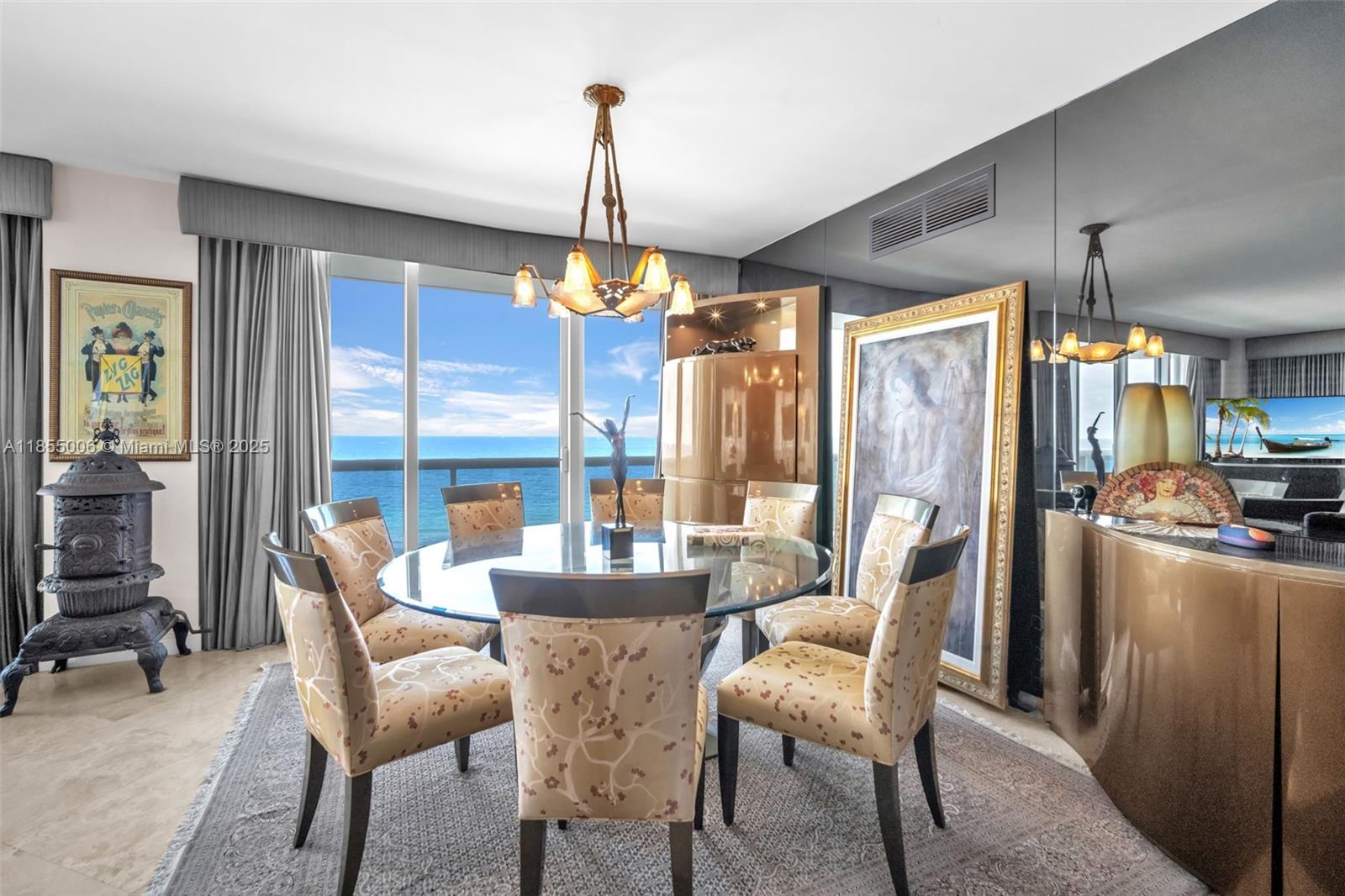 9595 Collins Avenue, Unit N9A Surfside, FL 33154 - Photo 23 of 66 a dining room with furniture a chandelier and fireplace