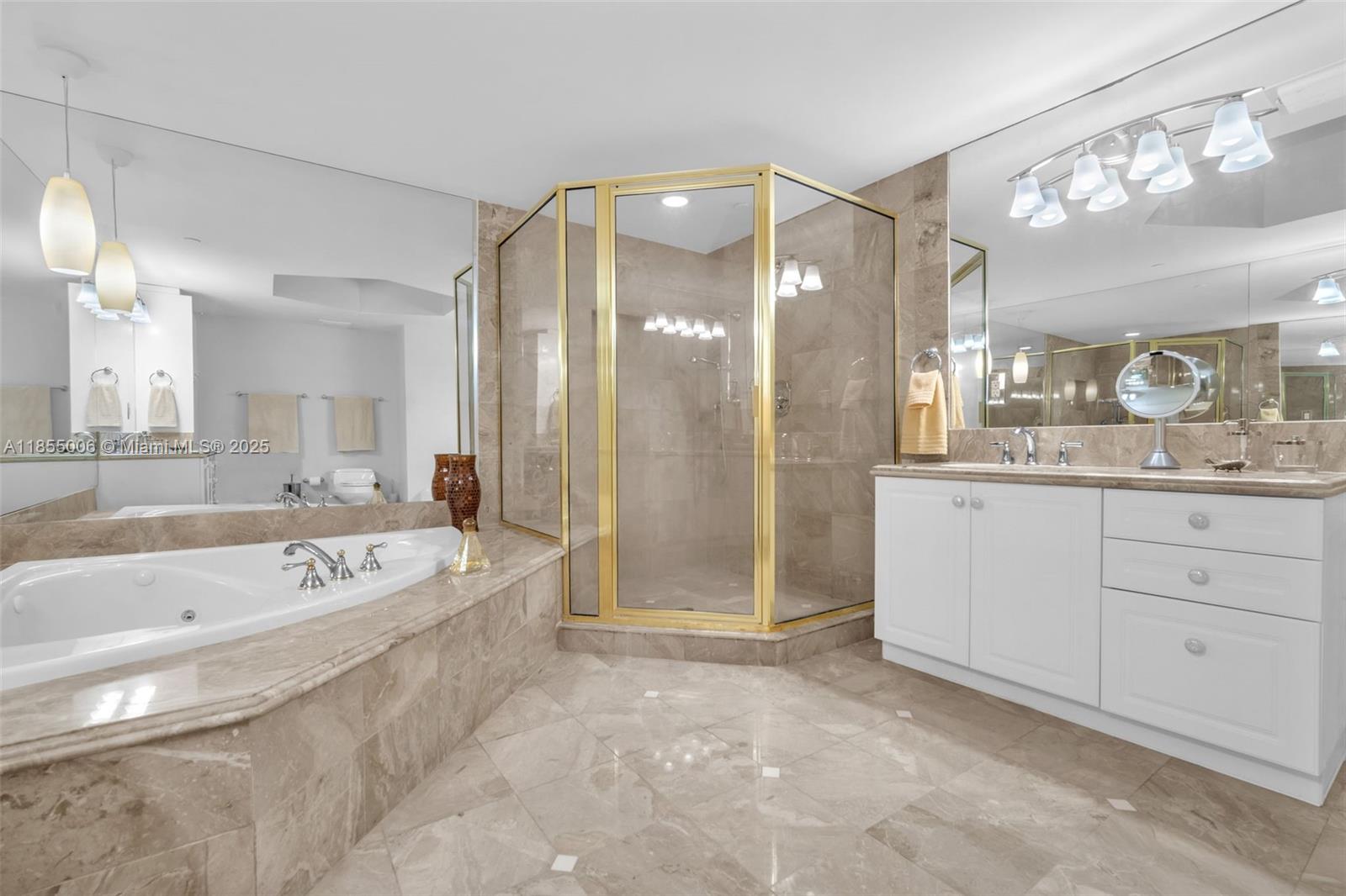 9595 Collins Avenue, Unit N9A Surfside, FL 33154 - Photo 37 of 66 a spacious bathroom with a granite countertop sink a mirror a shower and bathtub