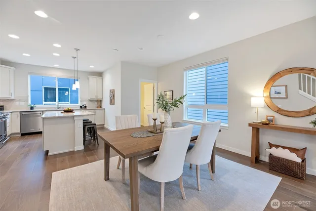 a view of a dining room with furniture and a chandelier