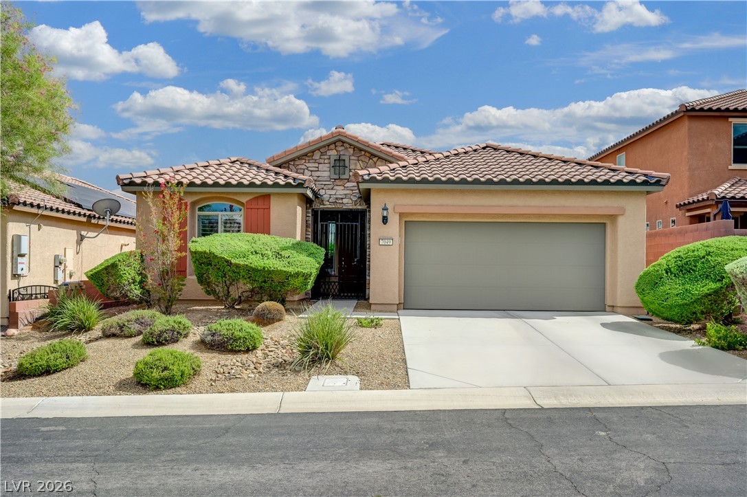 7049 Motley Road Las Vegas, NV 89178 - Photo 1 of 61 A classic tiled roof and stone accents elevate this beautiful modern elevation.