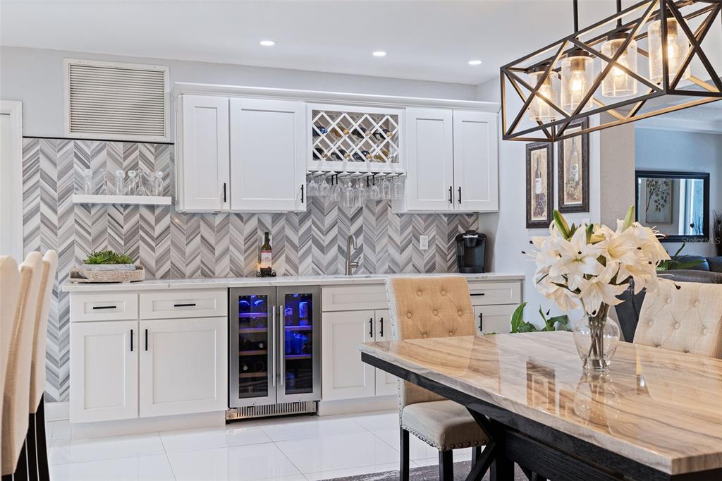 4781 97th Way North St. Petersburg, FL 33708 - Photo 12 of 47 a view of kitchen island with stainless steel appliances stove refrigerator table and chairs