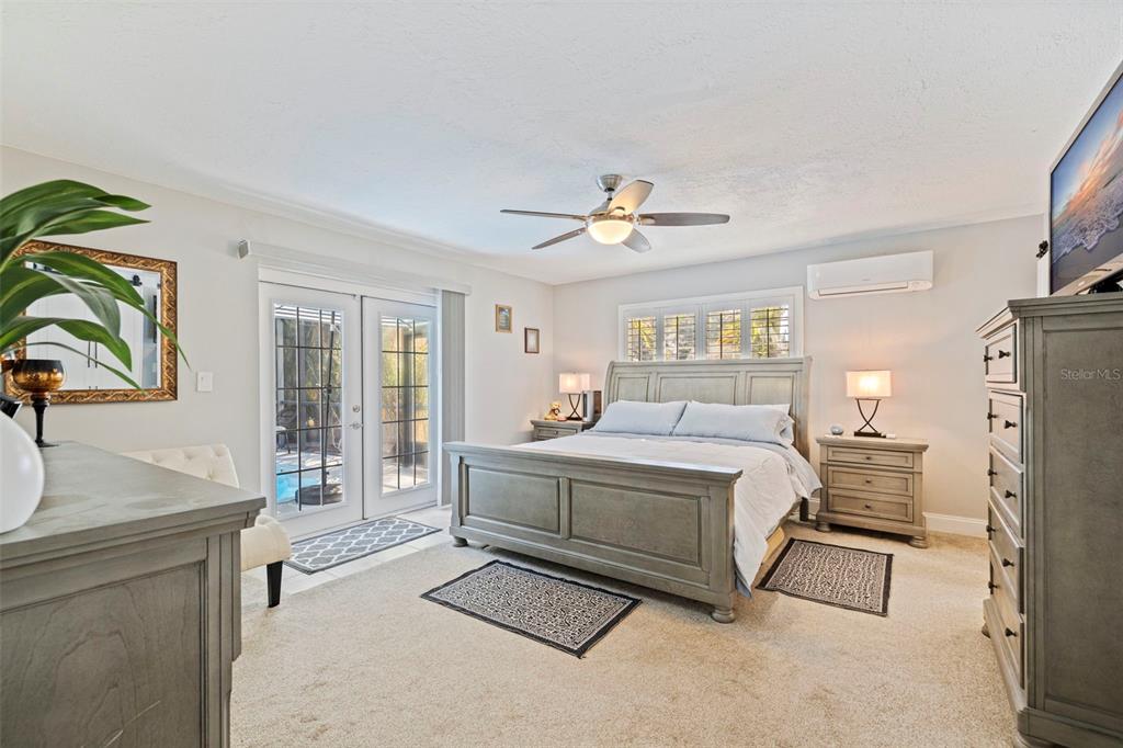 4781 97th Way North St. Petersburg, FL 33708 - Photo 17 of 47 a bed room with a bed and a chandelier