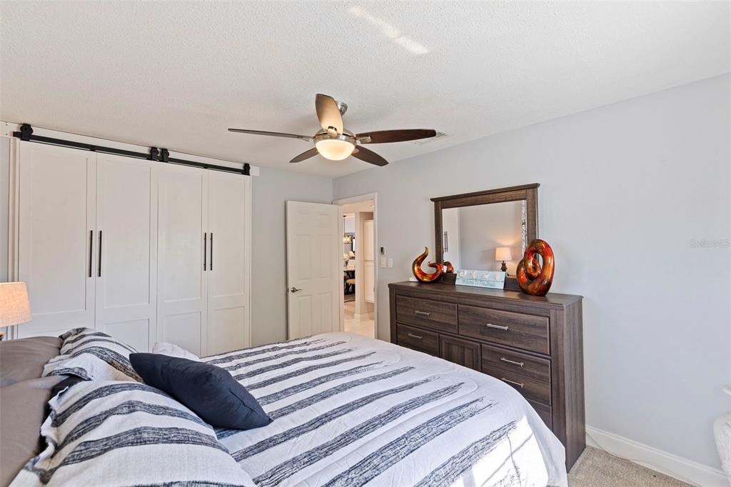 4781 97th Way North St. Petersburg, FL 33708 - Photo 24 of 47 a bedroom with a bed and a chandelier