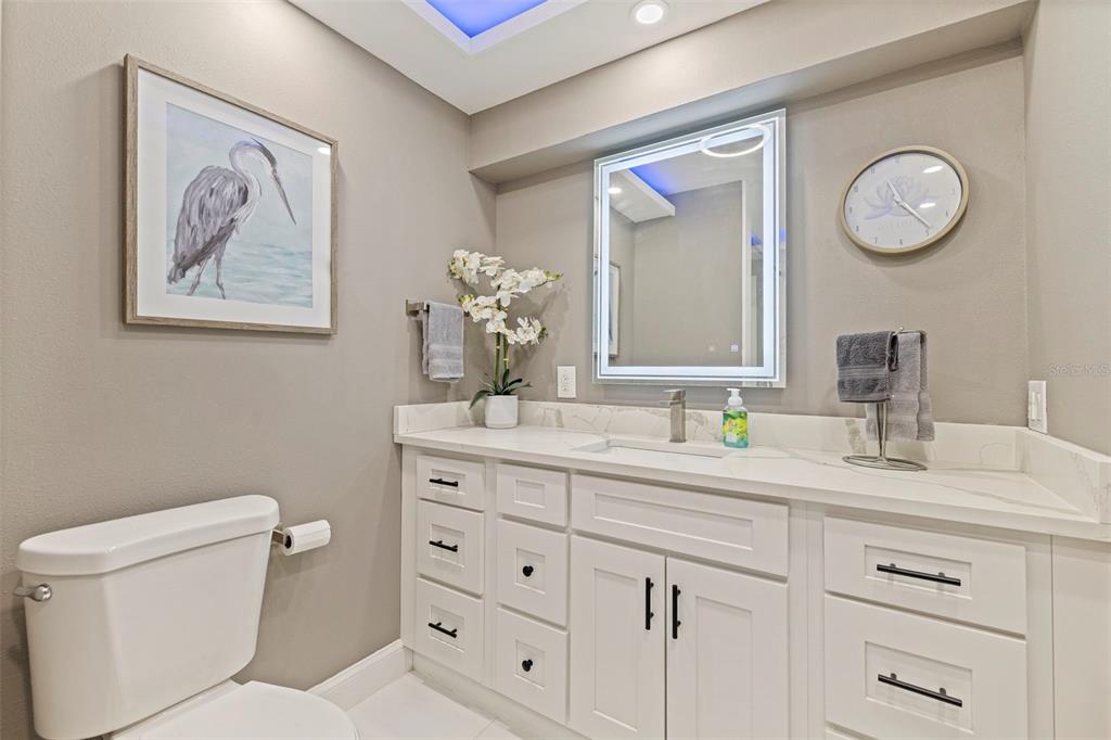 4781 97th Way North St. Petersburg, FL 33708 - Photo 26 of 47 a bathroom with a toilet sink and mirror