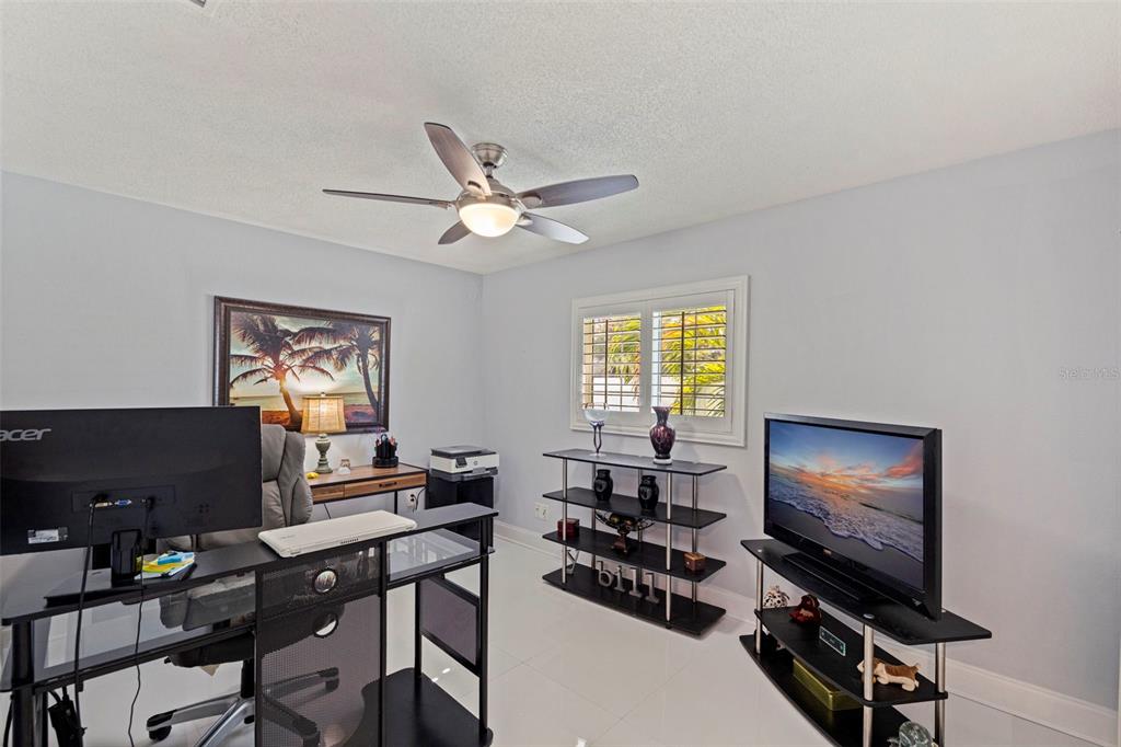 4781 97th Way North St. Petersburg, FL 33708 - Photo 27 of 47 a living room with furniture a window and a flat screen tv