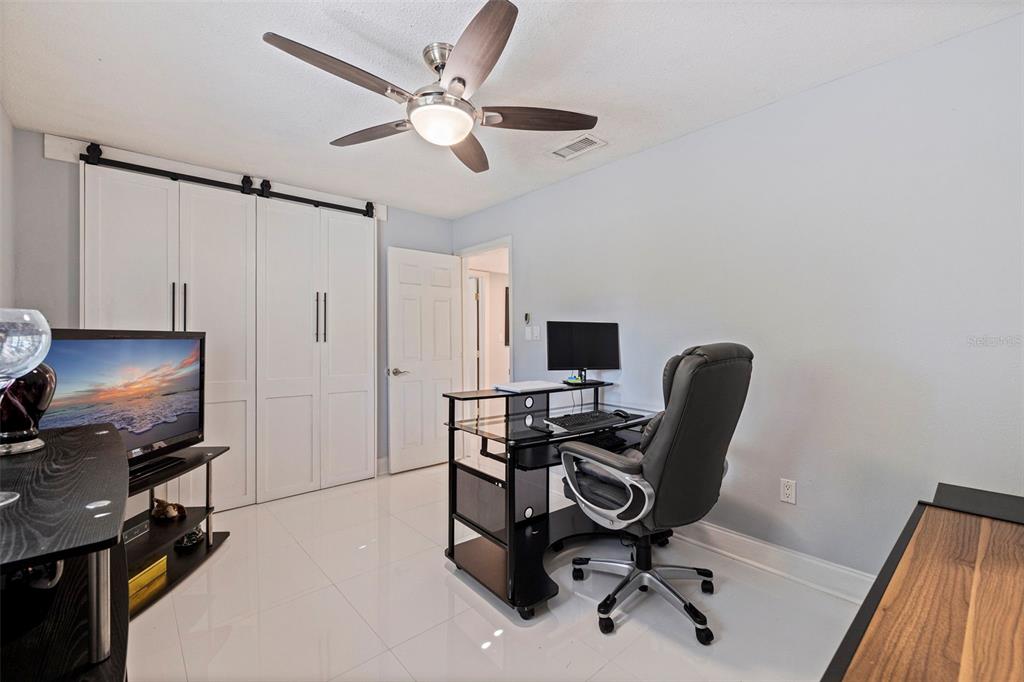 4781 97th Way North St. Petersburg, FL 33708 - Photo 28 of 47 a view of a workspace with furniture and a window
