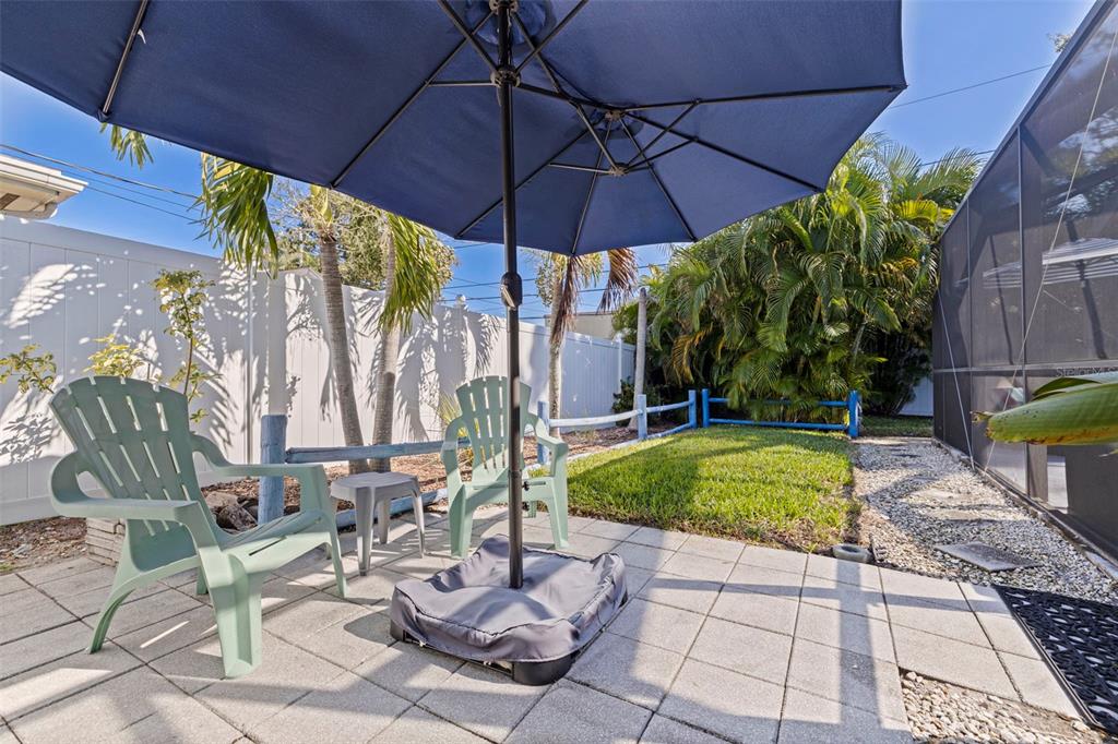 4781 97th Way North St. Petersburg, FL 33708 - Photo 34 of 47 a patio with a patio table and chairs