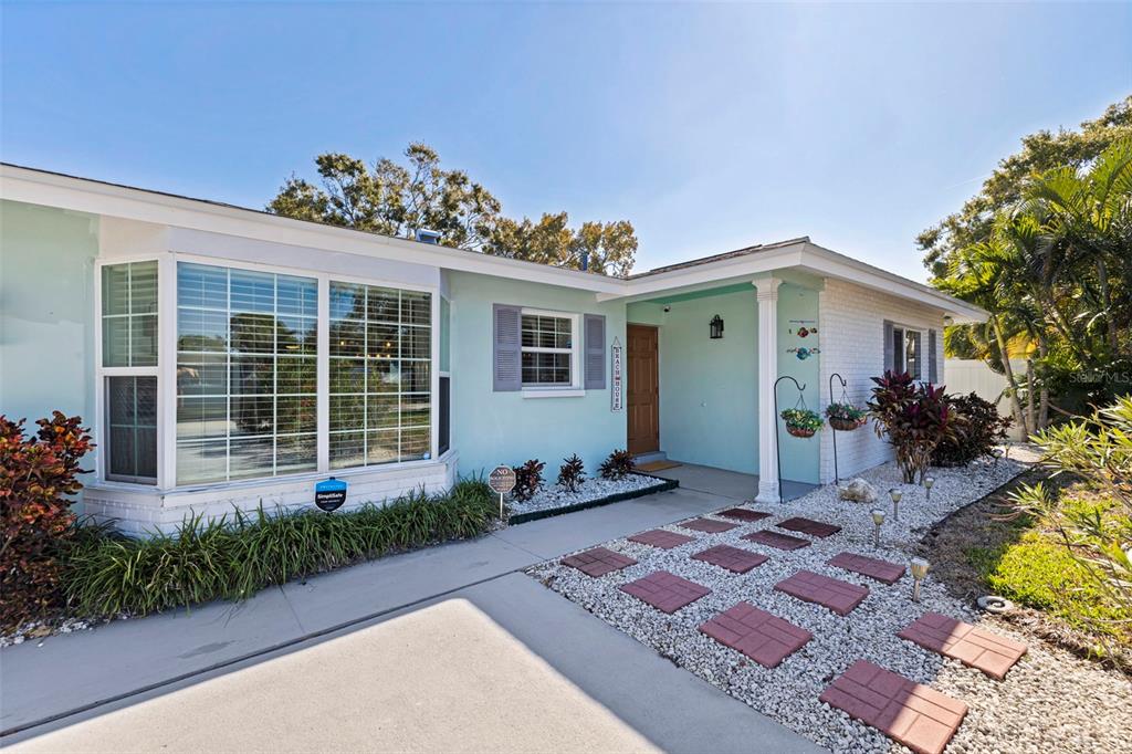 4781 97th Way North St. Petersburg, FL 33708 - Photo 5 of 47 a front view of a house with garden