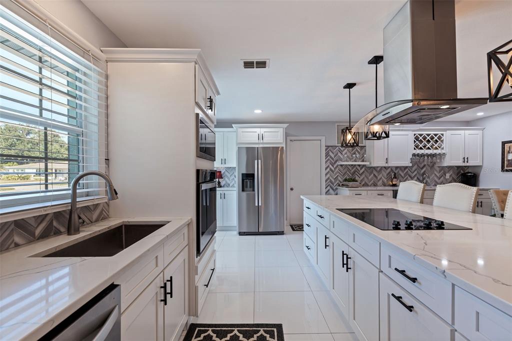 4781 97th Way North St. Petersburg, FL 33708 - Photo 7 of 47 a kitchen with a sink stove and refrigerator