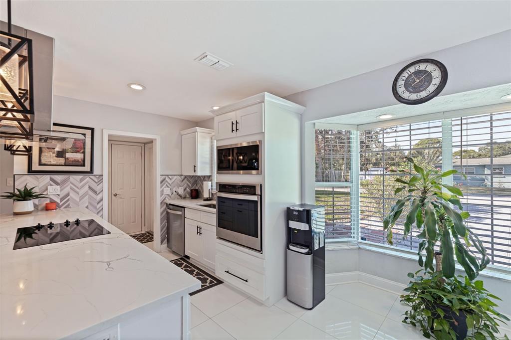 4781 97th Way North St. Petersburg, FL 33708 - Photo 8 of 47 a kitchen with a refrigerator and a stove top oven