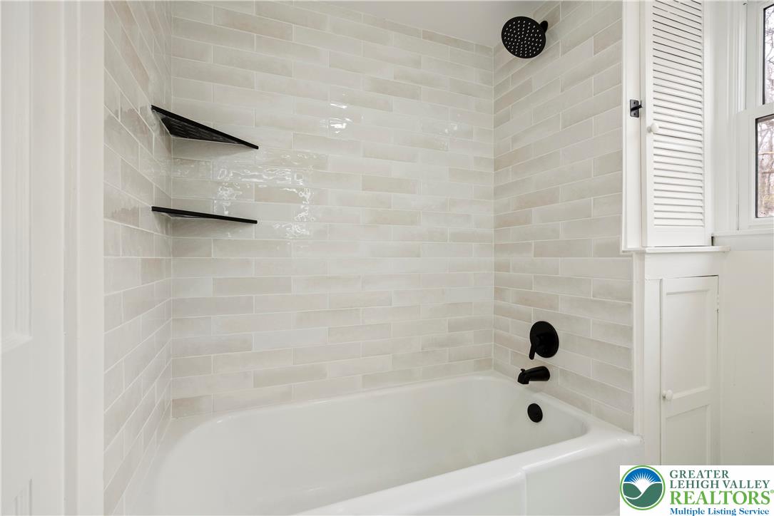 767 East Rock Road Allentown, PA 18103 - Photo 18 of 22 a bathroom with a bathtub and a shower