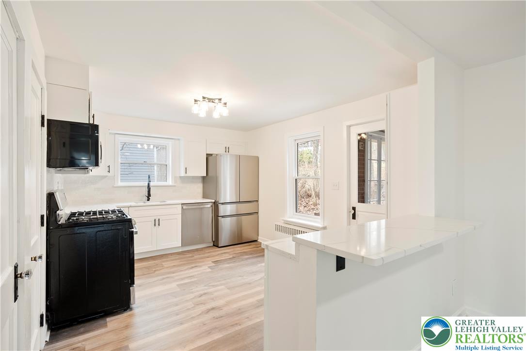 767 East Rock Road Allentown, PA 18103 - Photo 2 of 22 a kitchen with stainless steel appliances a refrigerator a stove a microwave and cabinets